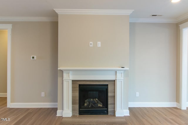 unfurnished living room featuring light hardwood / wood-style flooring and crown molding