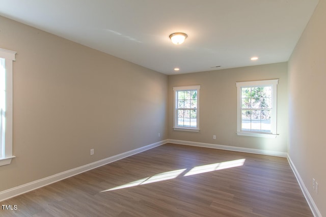 unfurnished room with hardwood / wood-style floors