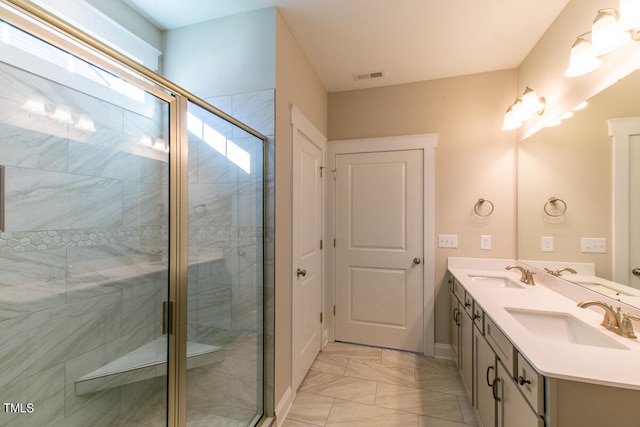 bathroom featuring tile patterned floors, dual bowl vanity, and a shower with door