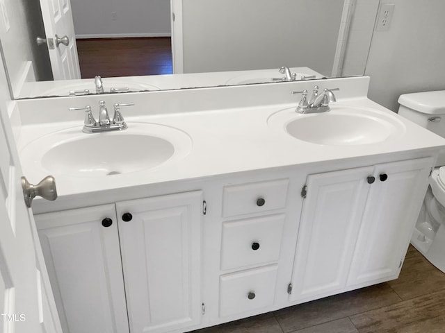 bathroom featuring double vanity, tile floors, and toilet