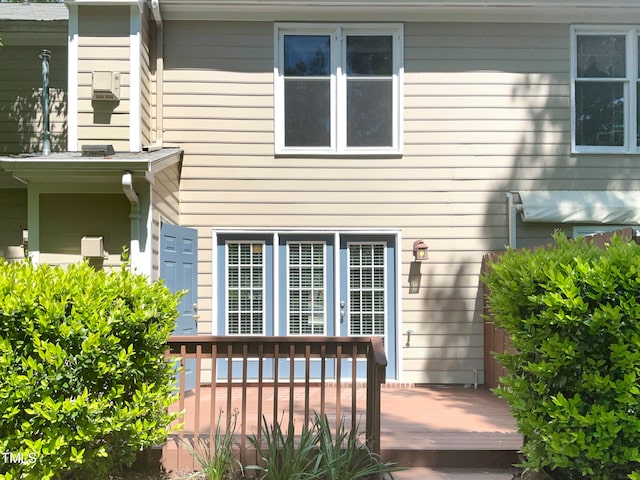 view of exterior entry featuring a deck