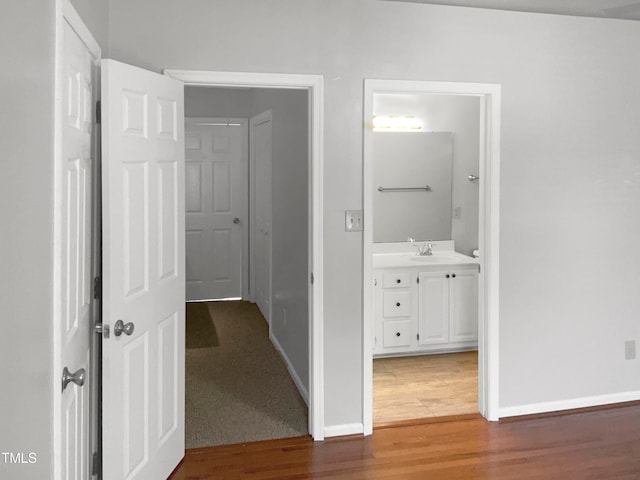 hallway with carpet and sink