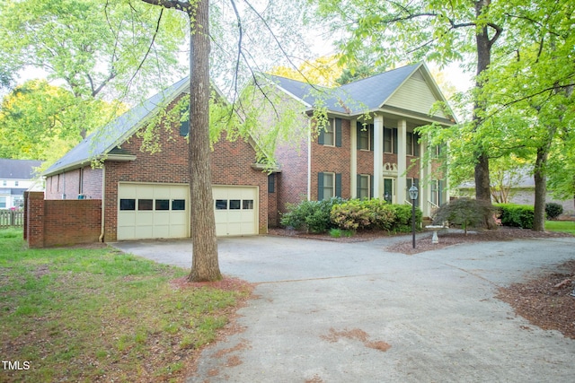 view of front of house featuring a garage, driveway, and brick siding