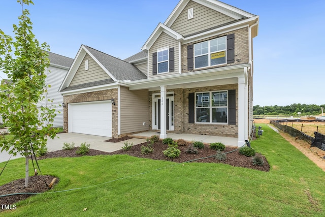 craftsman-style home featuring covered porch and a front lawn