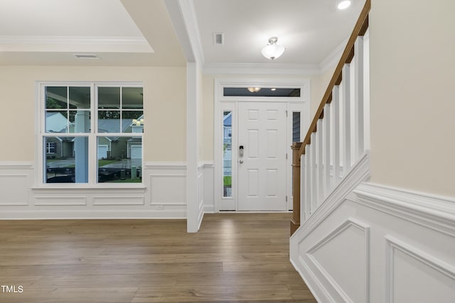 foyer featuring hardwood / wood-style floors and crown molding