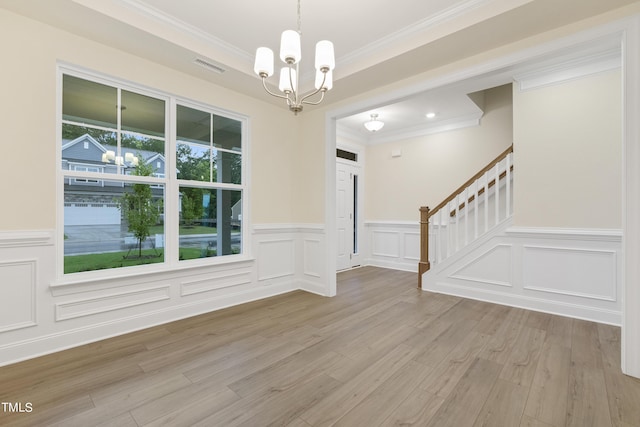 interior space with crown molding, light hardwood / wood-style floors, and a notable chandelier