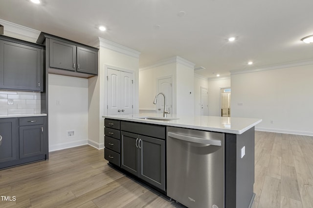 kitchen with an island with sink, dishwasher, light hardwood / wood-style flooring, and sink