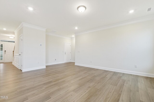 spare room with light wood-type flooring and ornamental molding