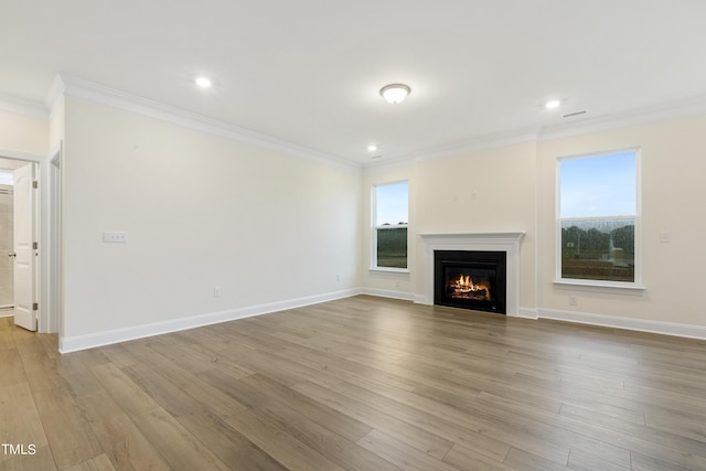 unfurnished living room with light wood-type flooring and crown molding