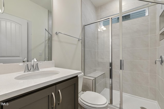 bathroom featuring toilet, walk in shower, and vanity