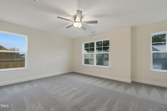 carpeted empty room featuring ceiling fan