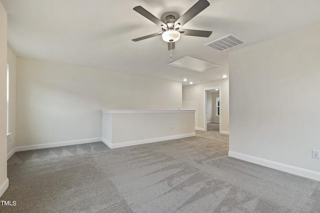 spare room featuring light carpet and ceiling fan