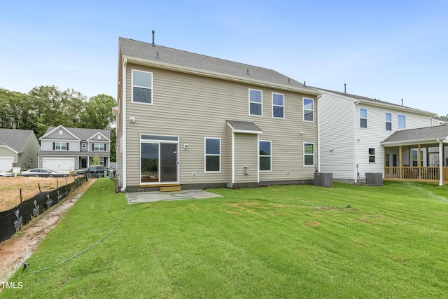 rear view of property with a lawn and cooling unit