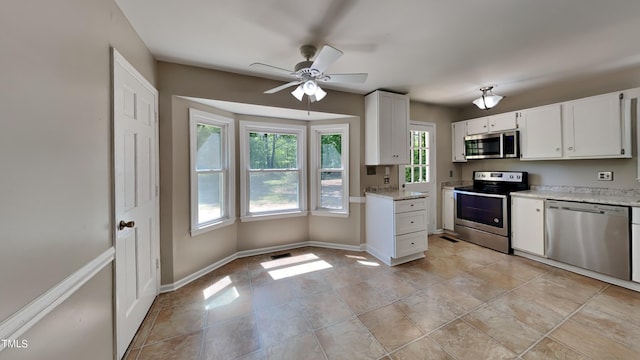 kitchen featuring appliances with stainless steel finishes, ceiling fan, white cabinets, and light tile floors