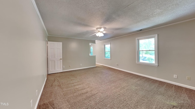 unfurnished room with ornamental molding, carpet flooring, ceiling fan, and plenty of natural light