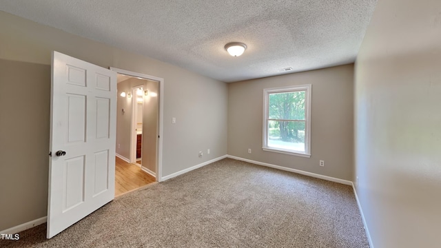 interior space with a textured ceiling and carpet floors