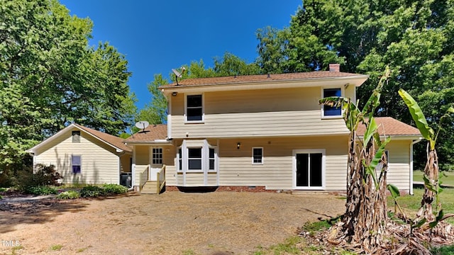 rear view of house with central air condition unit