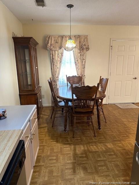 dining area featuring parquet floors