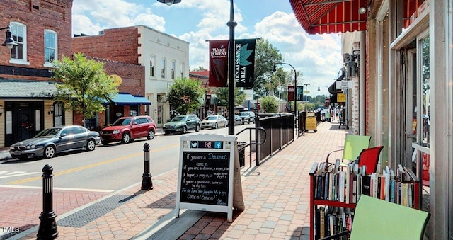 view of street featuring sidewalks, curbs, and street lights