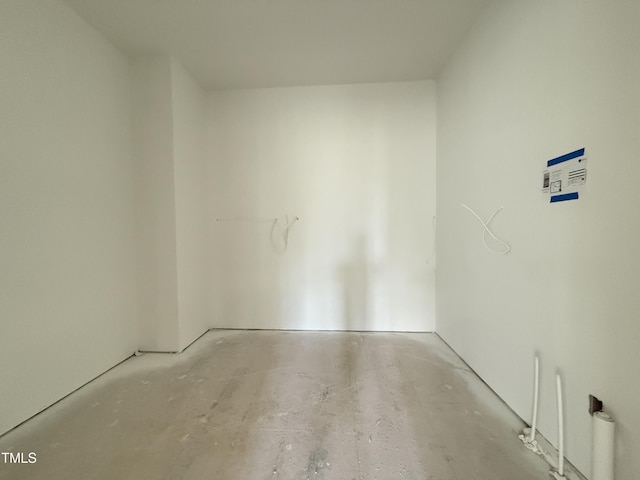 empty room with unfinished concrete flooring