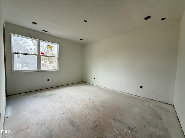 unfurnished room with visible vents