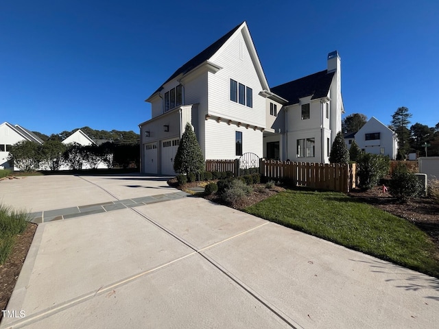 view of home's exterior featuring a garage and a lawn