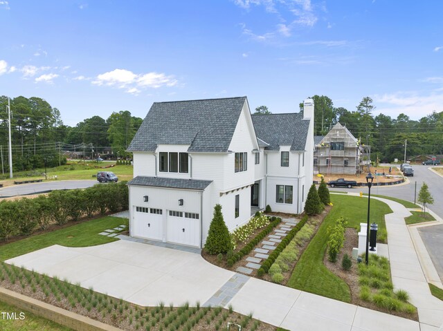 view of front facade with a garage and a front lawn