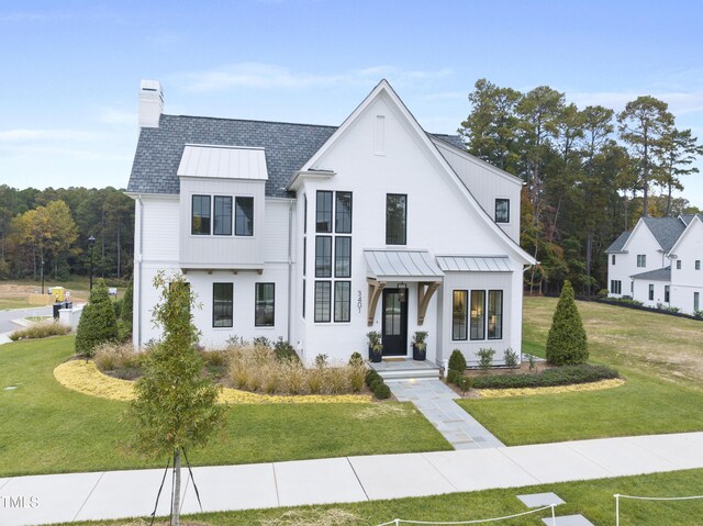 modern farmhouse with a front lawn