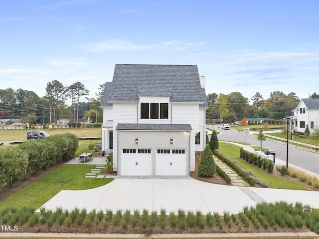 view of front of house featuring a garage and a front lawn