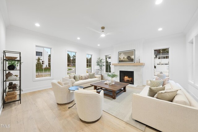3401 Makers Cir, Raleigh, NC 27612 - living room featuring ornamental molding, a lit fireplace, light wood-style flooring, a ceiling fan, and recessed lighting