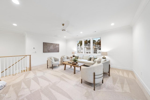 living room with ornamental molding, light colored carpet, and ceiling fan