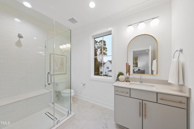 bathroom featuring vanity, walk in shower, and toilet