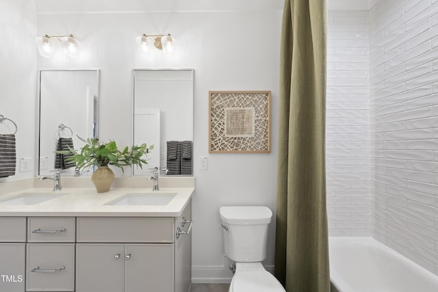 full bathroom featuring vanity, shower / bath combination with curtain, and toilet