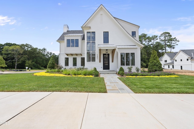 modern farmhouse featuring a front lawn