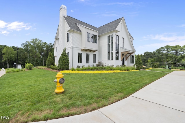 view of side of property with a yard