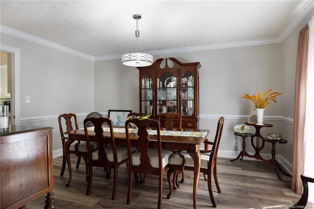 dining room featuring a textured ceiling, dark wood-type flooring, and crown molding