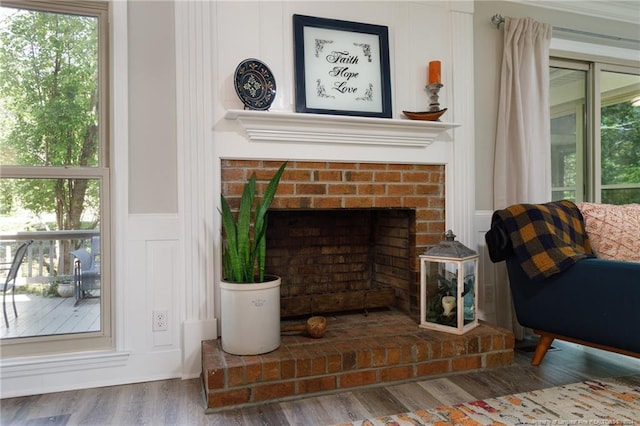 living room with dark wood-type flooring and a brick fireplace