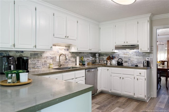 kitchen with hardwood / wood-style floors, white cabinets, and sink