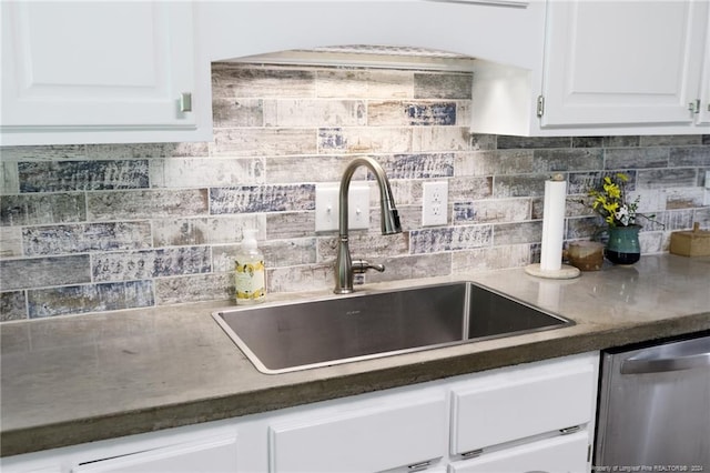 kitchen featuring sink, dishwasher, backsplash, and white cabinetry