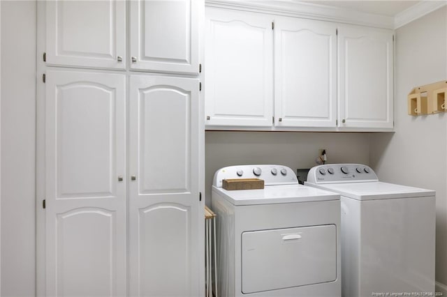 laundry room with crown molding, washing machine and dryer, cabinets, and hookup for a washing machine