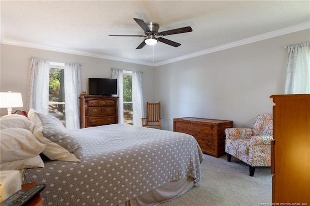 carpeted bedroom featuring ceiling fan and ornamental molding