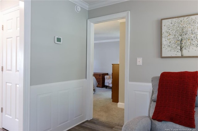 interior space with ornamental molding and dark colored carpet