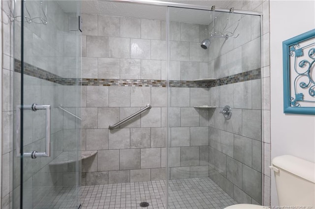 bathroom featuring walk in shower and toilet