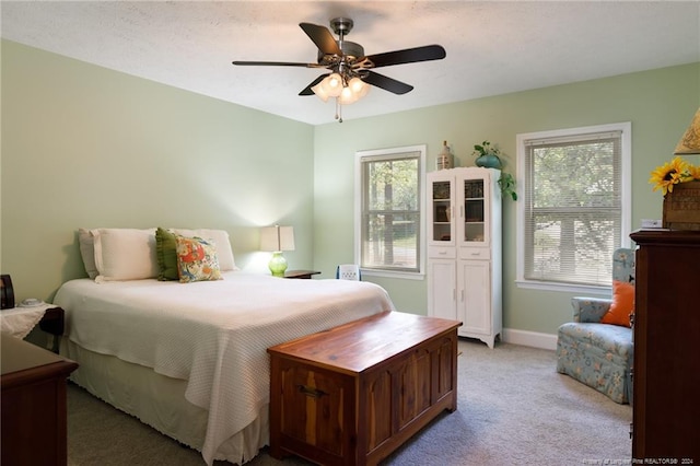 bedroom featuring ceiling fan and light carpet