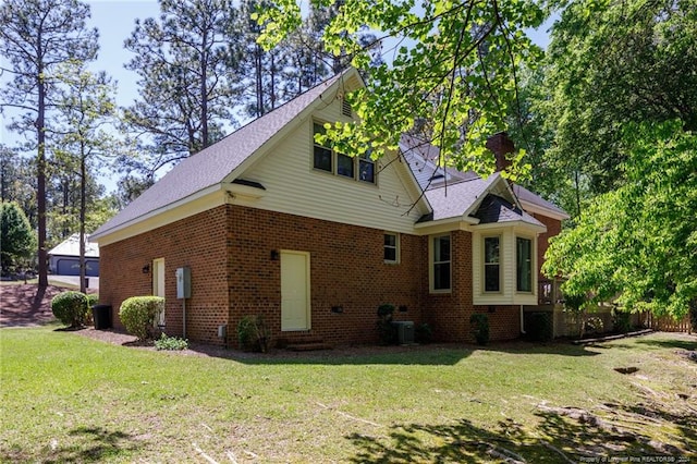 rear view of property featuring a yard