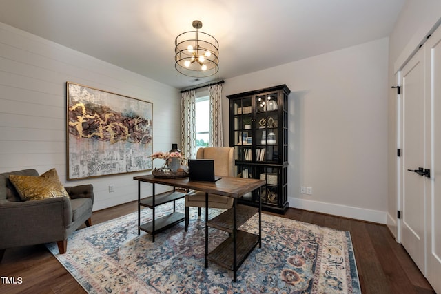 office space with dark wood-type flooring and a notable chandelier