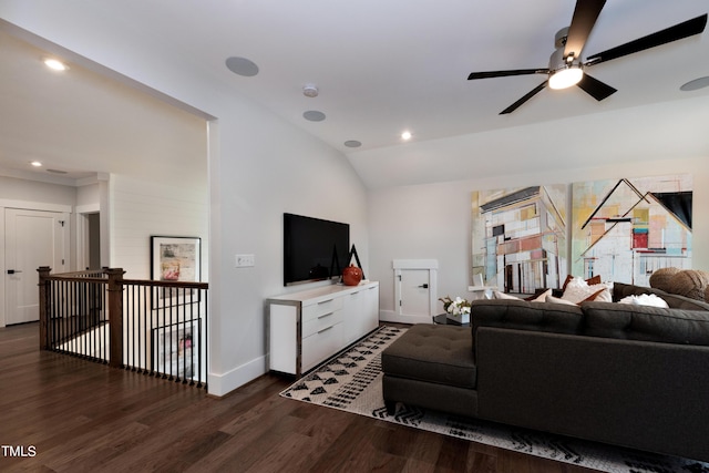 living room with ceiling fan, dark wood-type flooring, and vaulted ceiling