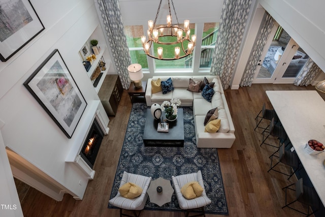 living room featuring a chandelier and dark hardwood / wood-style floors