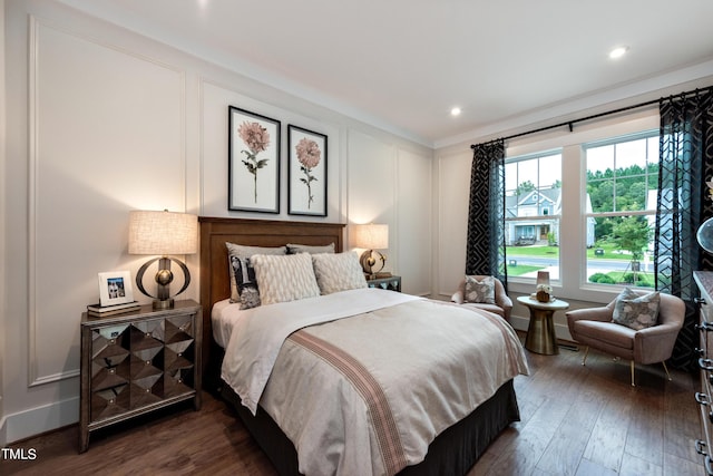 bedroom featuring dark hardwood / wood-style floors and crown molding