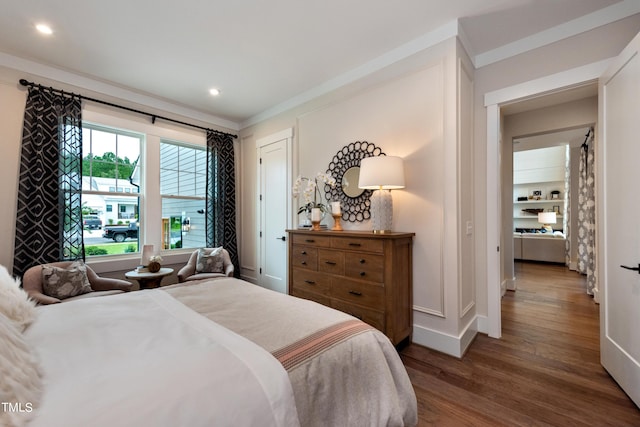 bedroom featuring ornamental molding and hardwood / wood-style floors